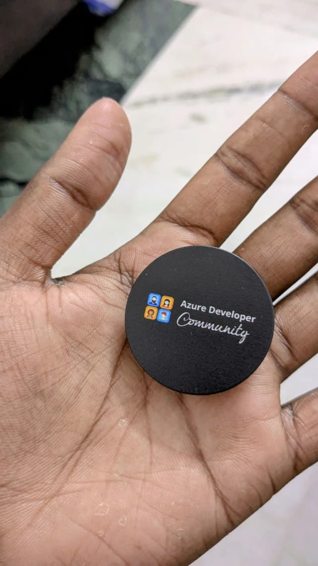 An Azure Developer Community badge in hand