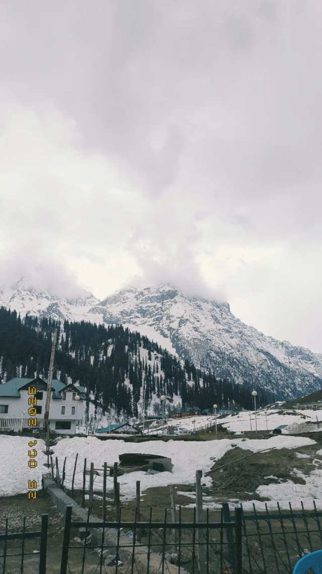 Snow-covered peaks under a heavy sky